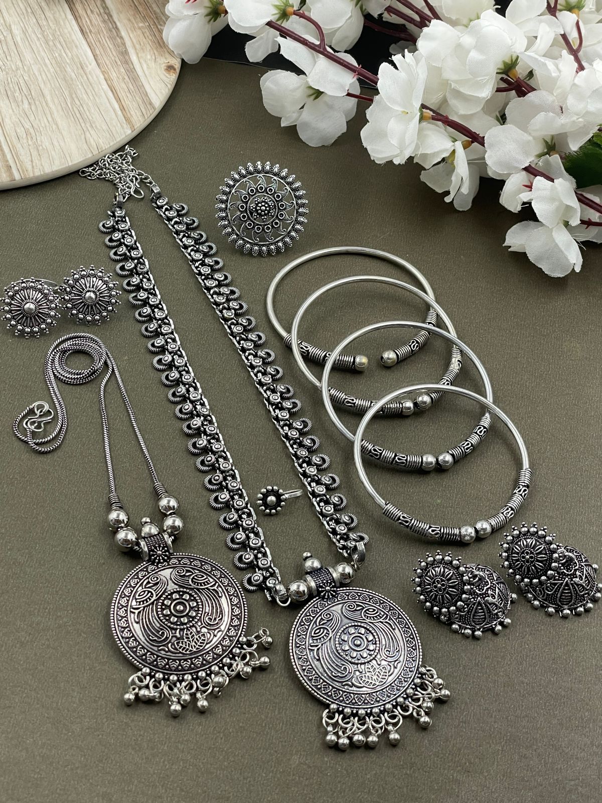Oxidized jewelry set featuring two pendants of Peacock design, a ring, earrings, kada, nosepin, and toe ring, all crafted in brass with intricate detailing.