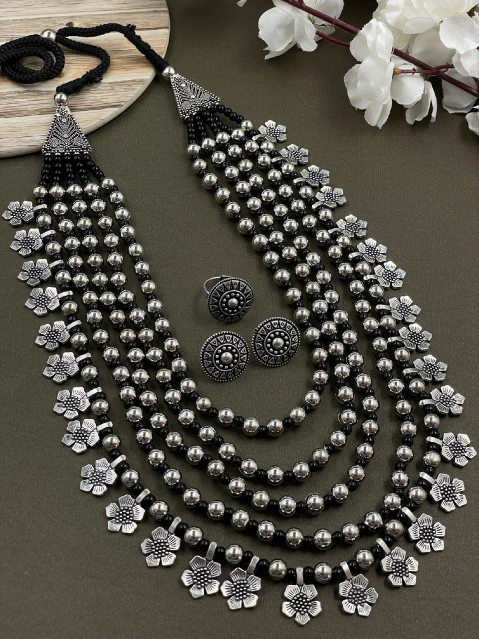 Image of a 5-layer oxidized mala jewelry set with flower charms, crafted in brass material, paired with matching ring and stud earrings for a coordinated look.