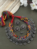 Load image into Gallery viewer, Threaded choker set in Multicolour with an oxidized brass necklace featuring heart and flower designs, complemented by matching flower  ring, studs, and nosepin