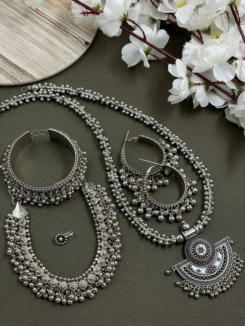 Oxidised crafted ghungroo jewelry set including a moon Pendant , choker, earrings , ring, nosepin, and kada, all made with intricate ghungroo detailing and traditional design.