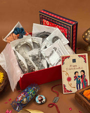 Silver Rakshabandhan hamper full contents flatlay - Naman Arts