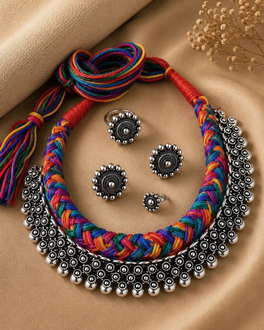 Traditional oxidised silver choker necklace set with multicolour thread design, matching earrings, ring, and nose pin for ethnic wear.