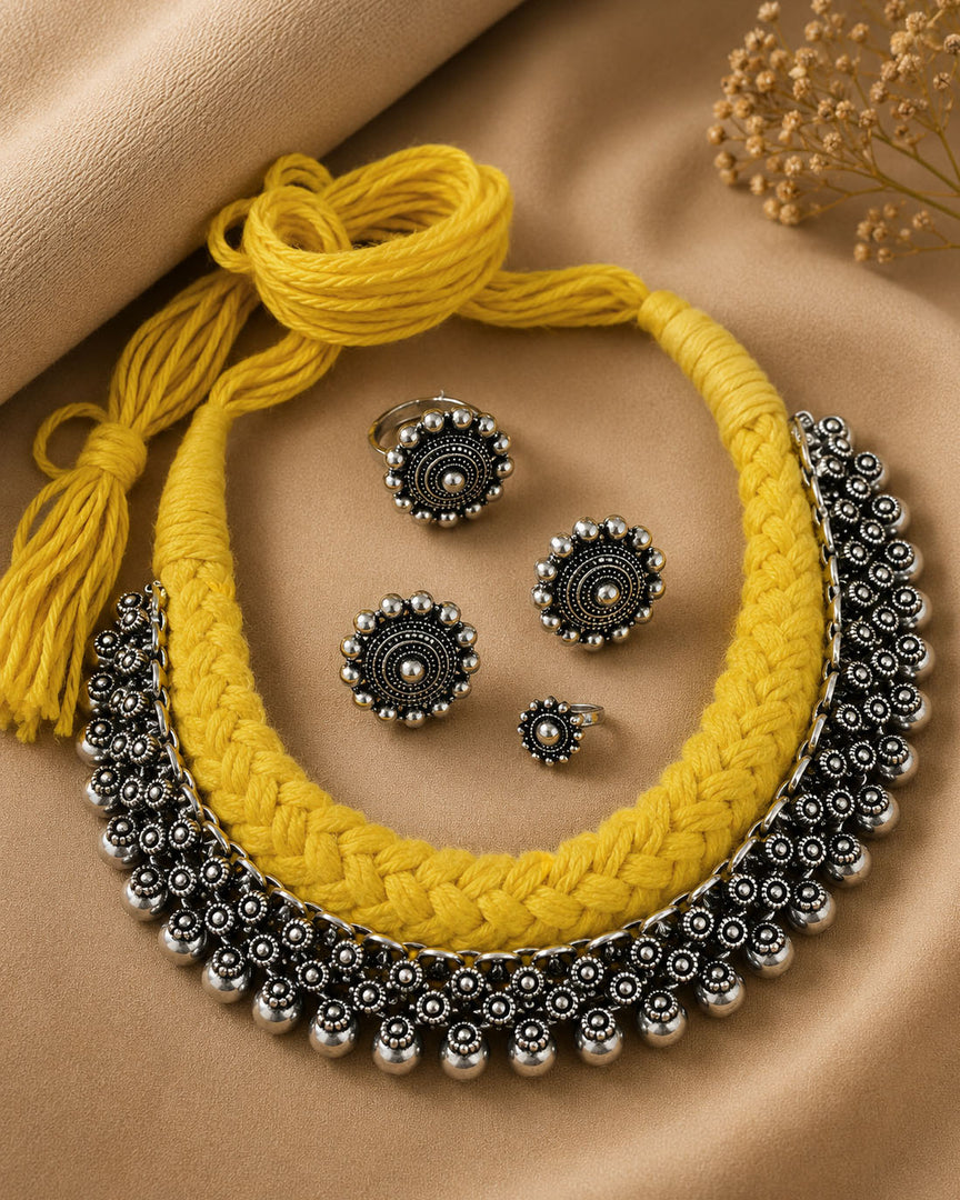 Traditional oxidised silver choker necklace set with yellow 
thread design, matching earrings, ring, and nose pin for ethnic wear.