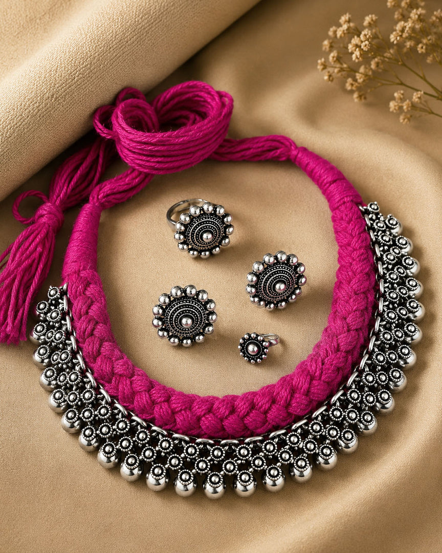 Traditional oxidised silver choker necklace set with pink thread design, matching earrings, ring, and nose pin for ethnic wear.