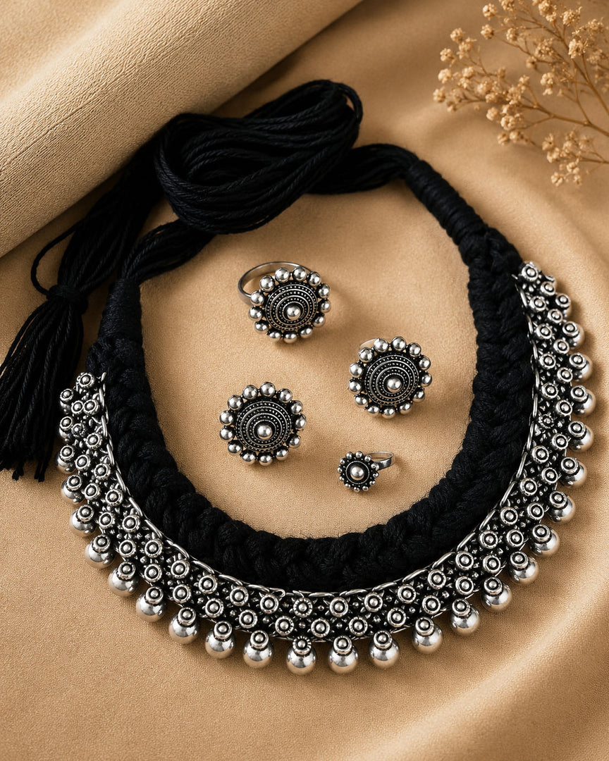 Traditional oxidised silver choker necklace set with black thread design, matching earrings, ring, and nose pin for ethnic wear.